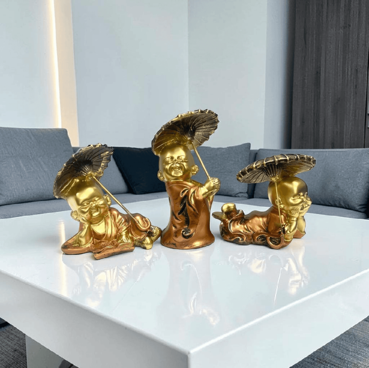 Golden laughing Buddha statues with umbrellas, decorative home accents for living room tables