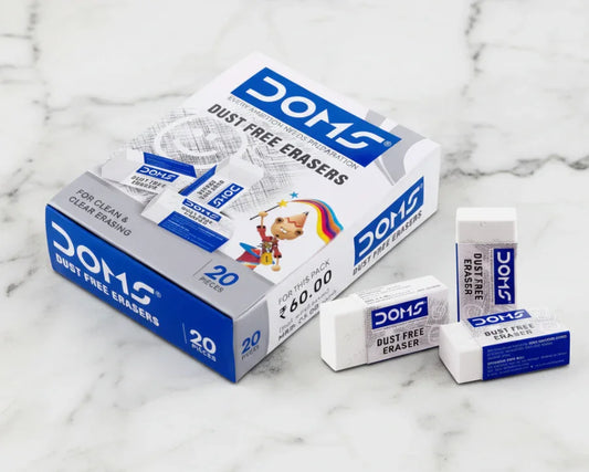 Box of DOMS dust free erasers with three erasers displayed on a marble surface.