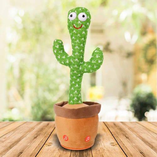 Dancing cactus plush toy in a brown pot with smiling face on a wooden table, indoor setting
