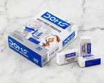 Box of DOMS dust free erasers with three erasers displayed on a marble surface.