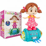 A toy dancing girl doll with brown pigtails and a pink floral dress, standing on a turquoise dance base with colorful light effects, shown next to its retail box on a white background.