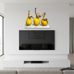 Yellow fruit-shaped sculptures with bird figurines on a shelf in a modern living room