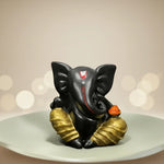 Black Lord Ganesha idol with gold accents for car dashboard or home decor