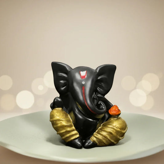 Black Lord Ganesha idol with gold accents for car dashboard or home decor