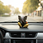 Black and gold Lord Ganesha idol for car dashboard, decorative Ganesh figurine in vehicle.