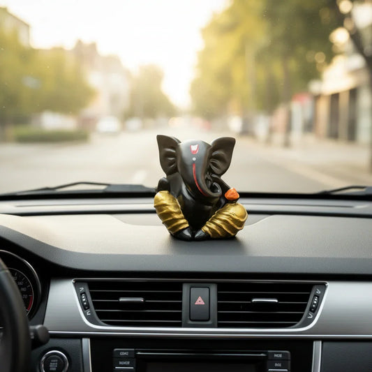 Black and gold Lord Ganesha idol for car dashboard, decorative Ganesh figurine in vehicle.