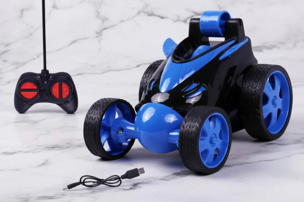 Blue and black stunt remote control car with controller and USB charging cable on marble surface